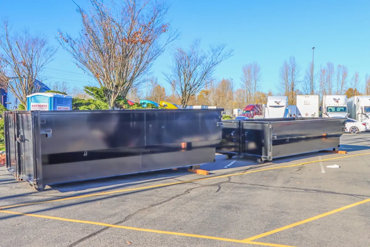 Professional dumpster rental service with roll-off container on residential driveway in Castroville